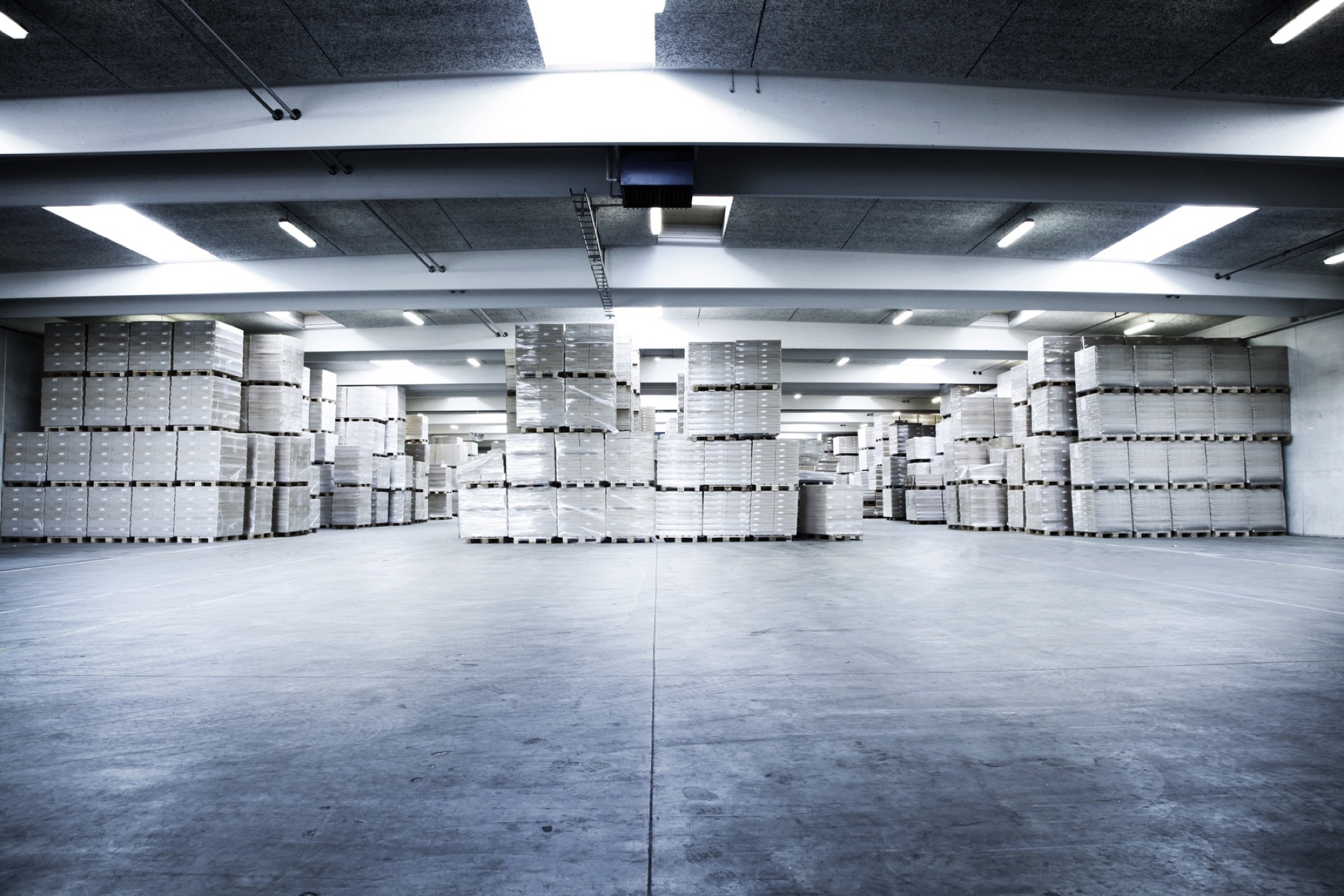 Tvilum finished-goods warehouse with flat-pack cartons stacked on pallets